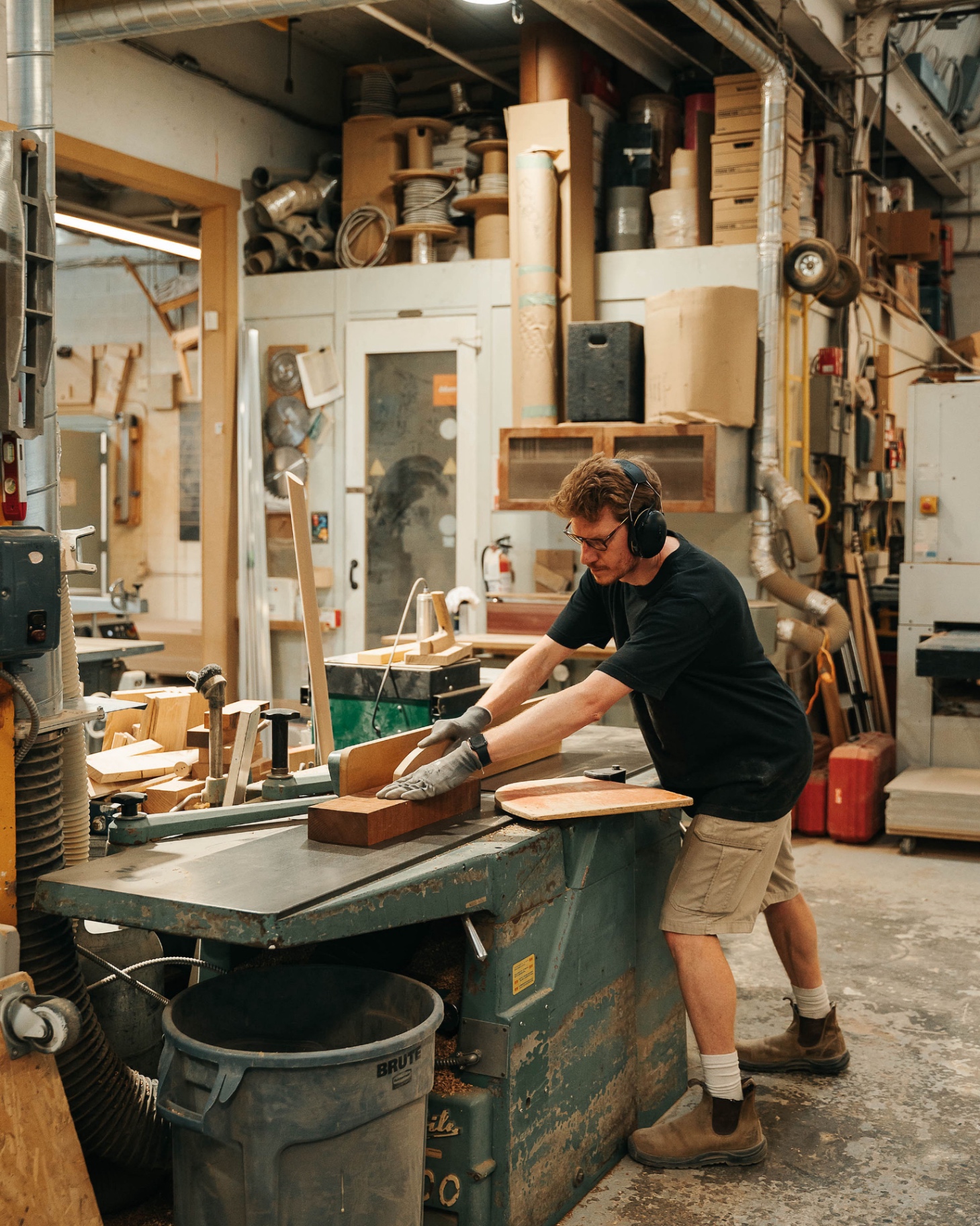 Martin working at the planer in the workshop